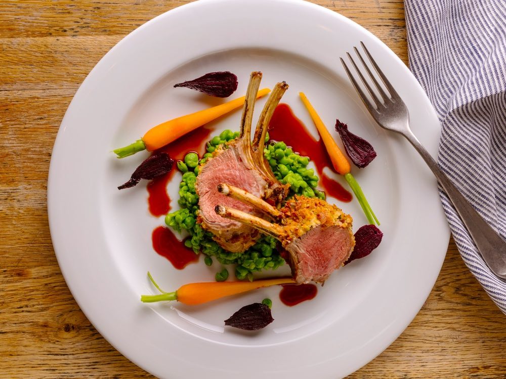 Herb-crusted lamb rack with red wine jus